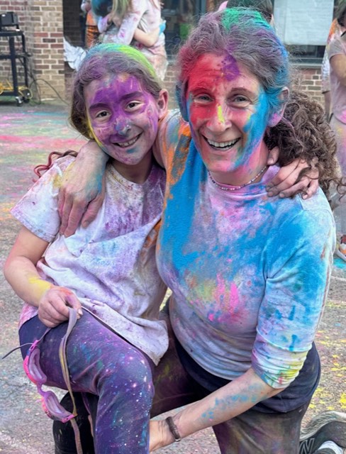 Eve and her mom covered head to toe in bright Holi powder
